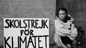 Picture by The Independent Greta Thunberg sitting with climate change saying SKOLSTREJK for klimatet 
